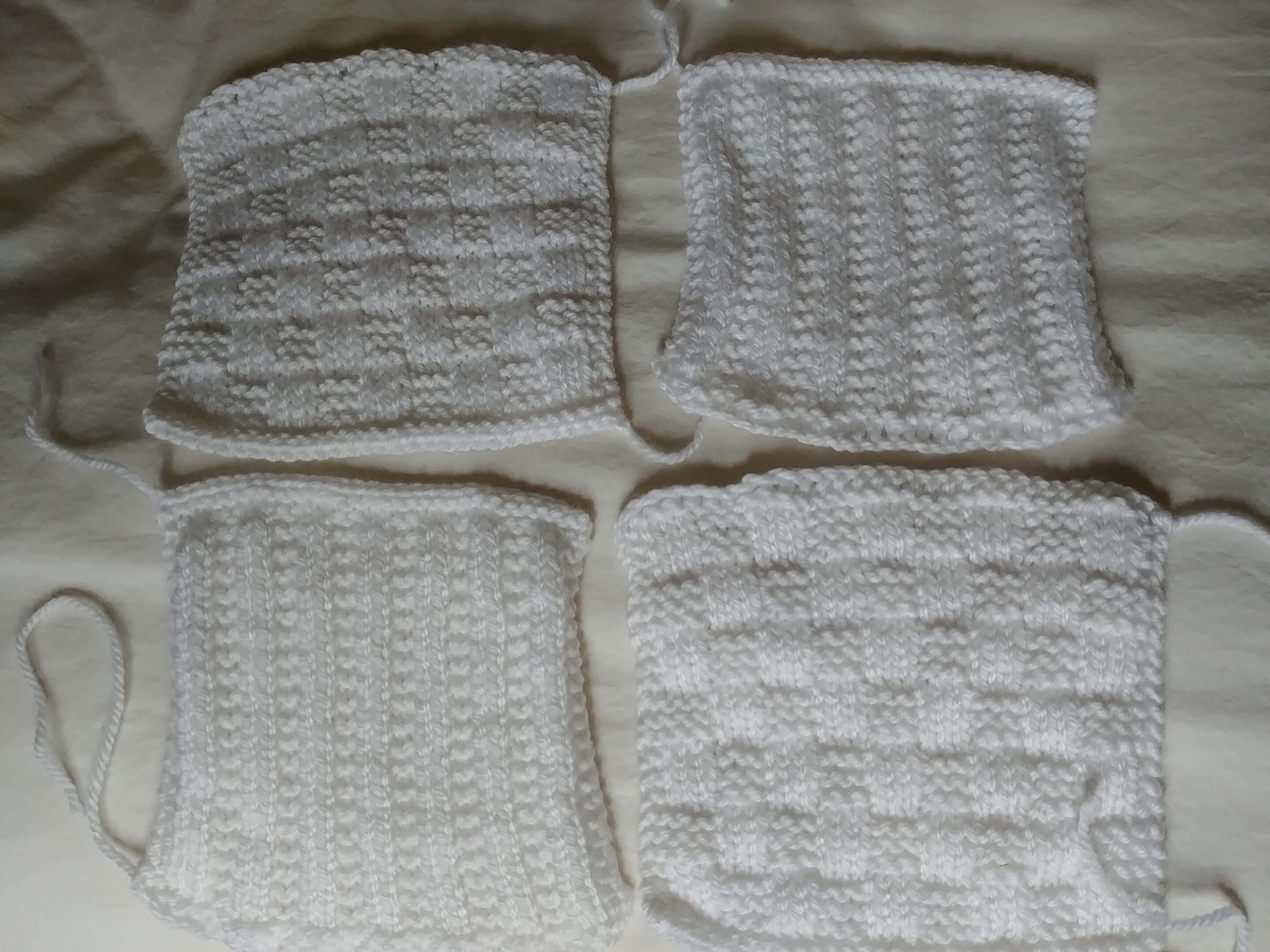 Four white squares knit with textured stripe and checkerboard stitch patterns