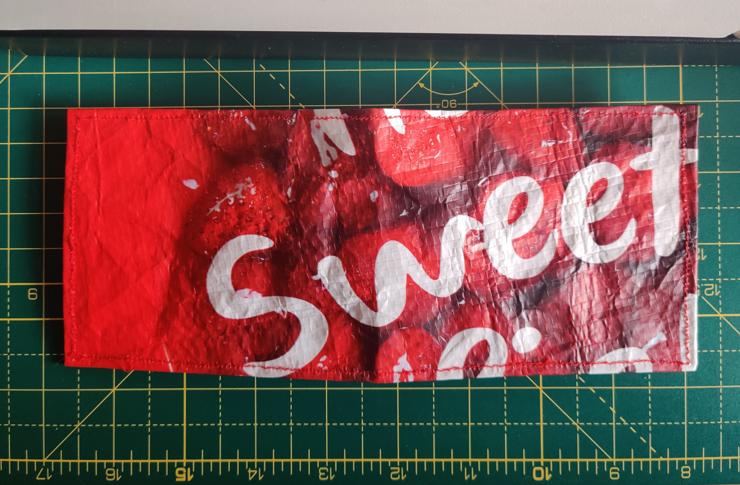 outside of the wallet that says the word "sweet" across it, clearly cut from a bigger message